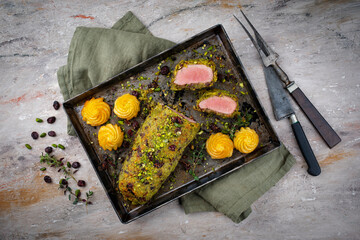 Fried mangalica pork tenderloin coated with crashed pistachio nuts, grated parmesan and chopped...
