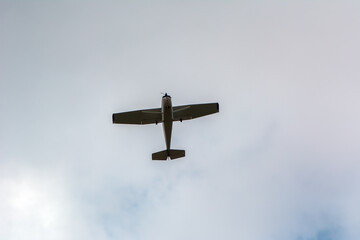 An old plane against a cloudy sky. Blue and gray colors. Flight and freedom. The first aircraft of the world.