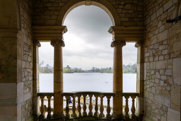 Hever Castle loggia on a cloudy spring afternoon, view over the lake, Hever, Kent, England