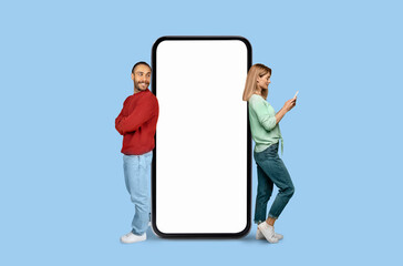 Smiling man and woman with giant smartphone