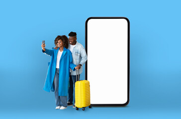 Couple makes selfie with smartphone mockup and luggage