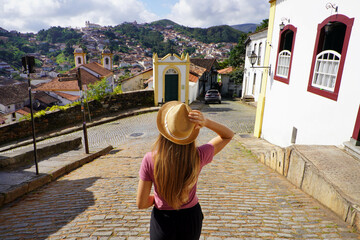 Holidays in Ouro Preto, Brazil. Back view of traveler woman descends street in the historic city of Ouro Preto, UNESCO World Heritage Site, Minas Gerais, Brazil.