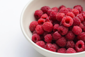 Fresh raspberry on white background.