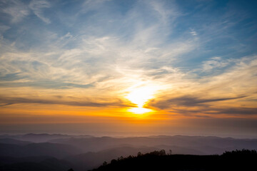 Fototapeta na wymiar Dramatic sunset sky over rolling mountains