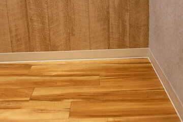 Wooden floor and wall with skirting boards