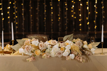 Boquet of orchid flowers and tulips on arranged table. the table is decorated with flowers