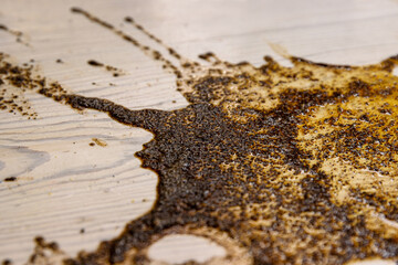 Coffee stains on white wooden table. Wood texture background. Big dark brown dramatic Splatter,...