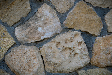 Granite stones of different shapes and colors. Wall cladding. Background selective focus with copy space. 1