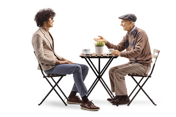 Young and elderly man having coffee and talking