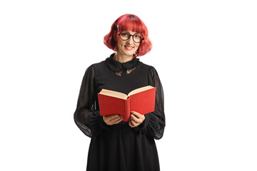 Young woman with red hair in a black dress holding a book