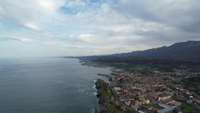 Drone, aerial 4k video view of beautiful coastal city of Llanes, Spain in Asturias