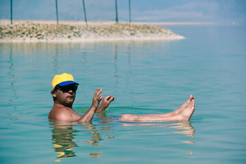 Floating in the Dead Sea, experiencing high salt content and weightlessness on water surface