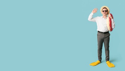 Office worker with inflatable ring and flippers dreaming about vacation on blue background with space for text © Pixel-Shot