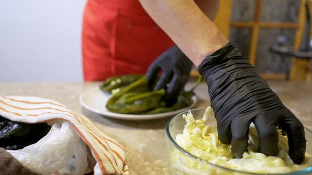 Chef stuffs a poblano chile with cheese to make chiles stuffed with cheese 