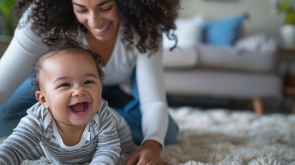 mother tickling her giggling baby, both of them beaming with happiness and love in their cozy living room. - obrazy, fototapety, plakaty