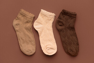 Different basic color socks on brown background