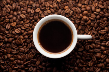 Cup coffee on coffee beans