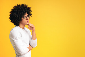 Thoughtful black man profile portrait on orange background