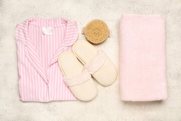 White slippers, pajamas and towel on white background. Top view