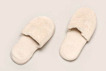 White soft slippers on grey background. Top view
