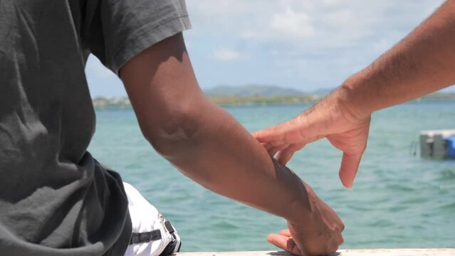 Men talking in front of Caribbean sea