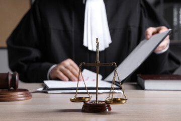 Justice scales on table of judge in office, closeup