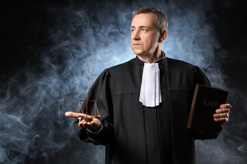 Mature judge with justice scales and law book on dark background - obrazy, fototapety, plakaty