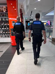 Australian Queensland Police officers patrol in shopping mall