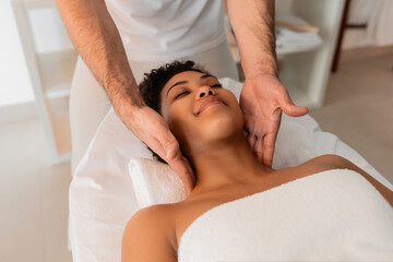 Fototapeta na wymiar Professional massaging the neck of a black lady
