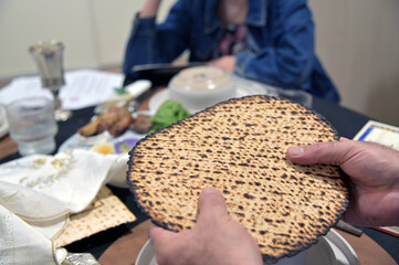 Jewish man hold handmade shmura matzo on Passover Seder Jewish Holiday