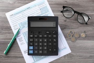 Tax accounting. Calculator, document, pen and coins on wooden table, flat lay