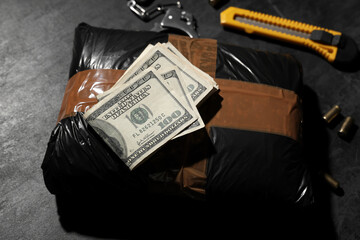 Drug package with money on dark background, closeup