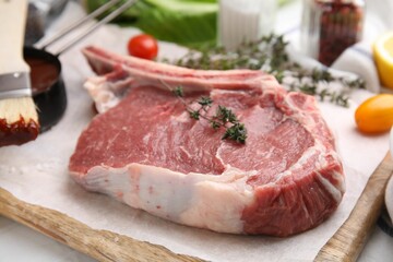 Raw meat, thyme and marinade on table, closeup