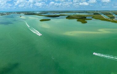 Boats zip across the ocean water in the Gulf of Mexico in Southwest Florida