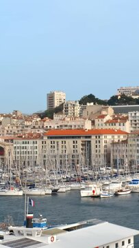 Marseille Old Port (Vieux-Port de Marseille) with yachts and Basilica of Notre-Dame de la Garde. Marseille, France. Camera pan