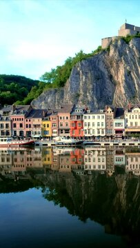 Picturesque view of Dinant town, Dinant Citadel and Collegiate Church of Notre Dame de Dinant over River Meuse. Belgium. Camera pan