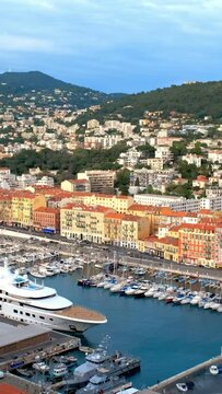 View of Old Port of Nice with luxury yacht boats, France, Villefranche-sur-Mer, Nice, Cote d'Azur, French Riviera. Horizontal camera pan