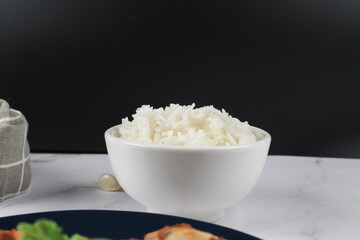 Thai Jasmine Rice in white bowl on table. Realistic Asian healthy food element.  