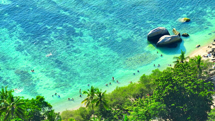 Koh Tao, a serene Thai island, boasts crystal-clear waters, vibrant coral reefs, and secluded beaches, perfect for diving and relaxation. Aerial view. Sea background.

