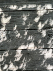 Eclipse Shadow on a wooden deck
