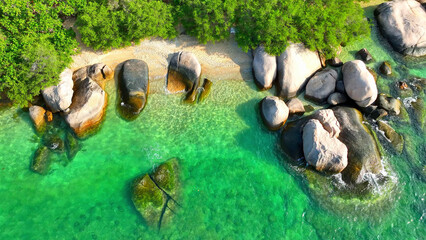 Immerse in the beauty of a secluded beach, where soft sands blend with rugged rocks, framed by...