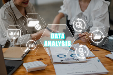 Data analysis concept, Business team analyzing income charts and graphs on office desk with data management, report, analysis, focus data, processing and optimization icon on virtual screen.