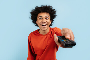 Excited black man with TV remote control