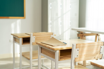 Shot of empty classroom with chairs under desks in elementary school. 