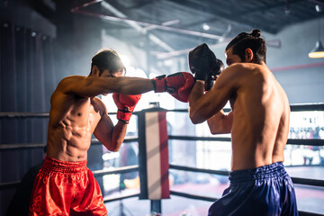 Two young professional boxer having a competition tournament on stage. 
