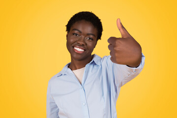 Happy african american woman giving thumbs up gesture