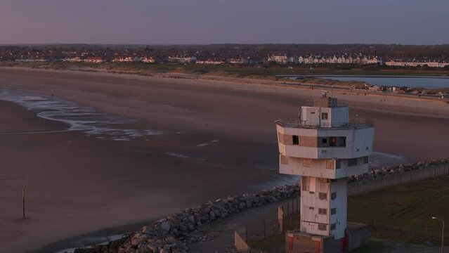 Aerial view of decommissioned Seaforth Radar Tower during sunset with crosby beach in background