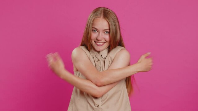 Come to me, I want to embrace you. Young woman spread hands and give hug to you. Pleasant expression, love feelings, proud, satisfied. Girl isolated alone on pink studio background. Lifestyles