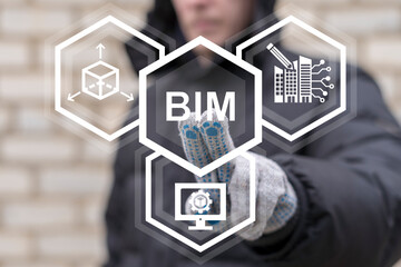 Worker using on virtual touch screen presses abbreviation: BIM. Building Information Modeling ( BIM...