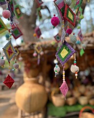 Colorful handmade souvenirs hang from the trees.